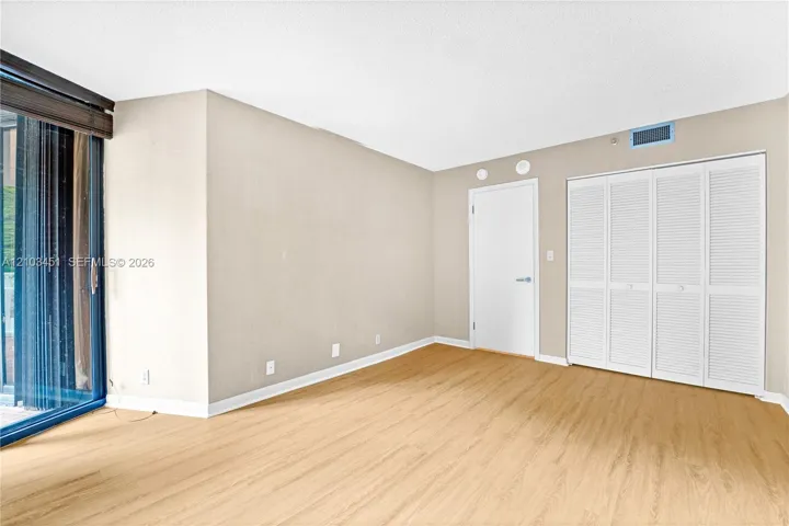 Second bedroom featuring direct access to the balcony. Picture yourself enjoying serene mornings and stunning sunsets!