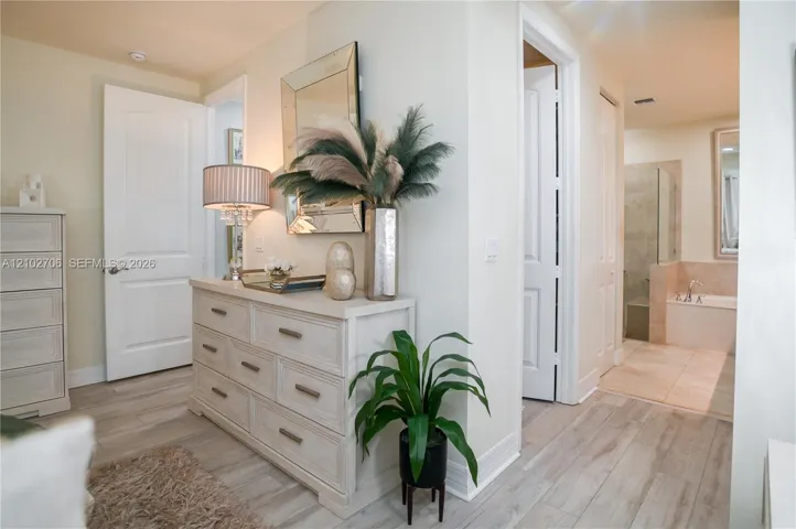 Wood-finish flooring, multi-panel interior doors, and neutral wall tones