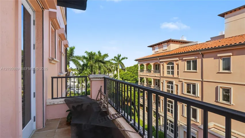 Private balcony with stone flooring and a black metal railing