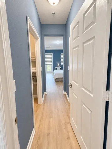 Bright blue-gray primary bedroom entry