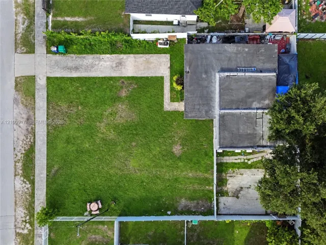 Expansive grassy yard with concrete pathways