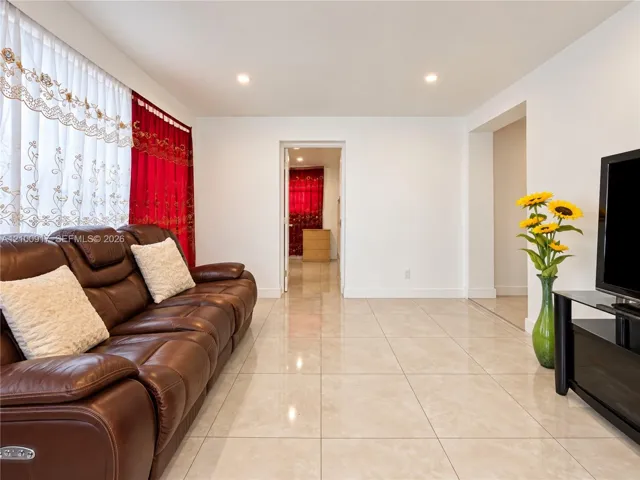 Recessed ceiling lighting illuminates the spacious interior featuring light-toned tile flooring