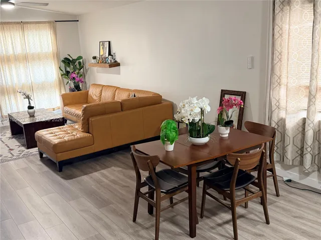 Open-concept living space featuring wood-finish flooring, recessed lighting, and a ceiling fan
