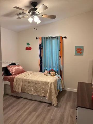 Wood-finish flooring with a neutral paint palette and crown molding