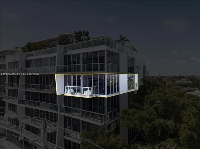 Expansive glass balcony with white railing, set within a modern high-rise building featuring extensive window walls