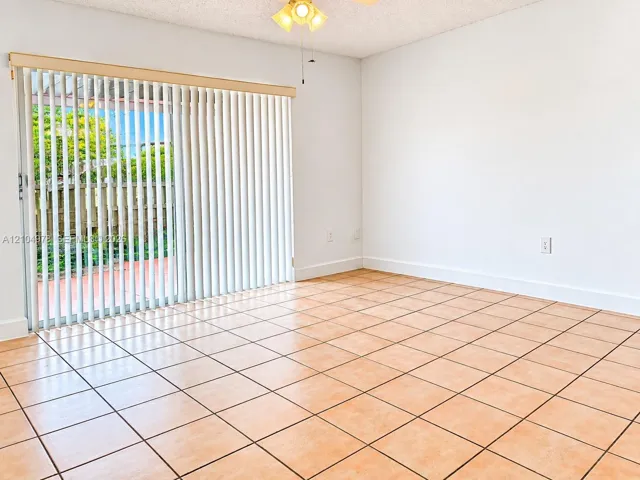 sliding glass door, vertical blinds, and ceiling fan