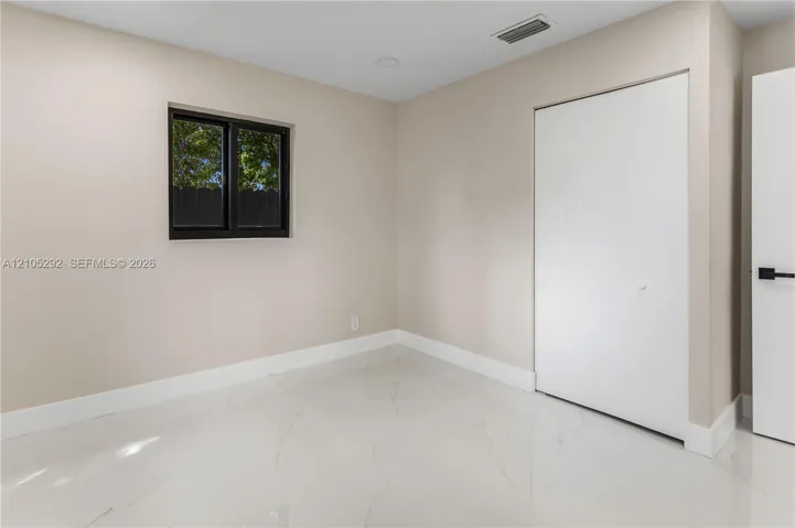 White tile flooring, neutral wall tones, bi-fold closet doors, and recessed lighting
