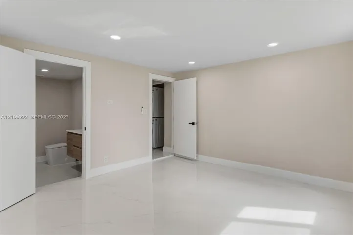 Polished tile flooring, recessed lighting, and a neutral wall color