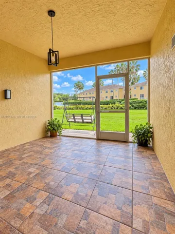 Screened patio with large format tile flooring and a modern pendant light fixture