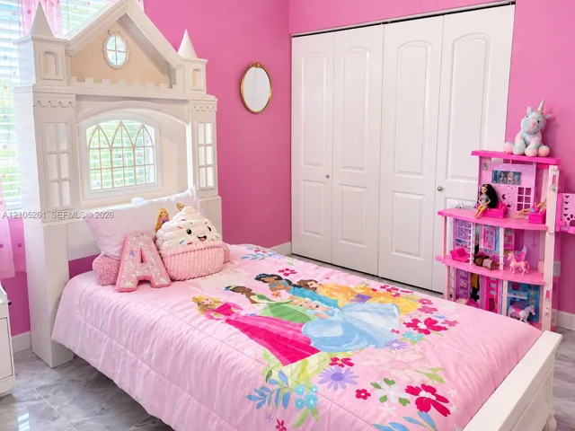 Recessed window, wood-finish flooring, and white bi-fold closet doors