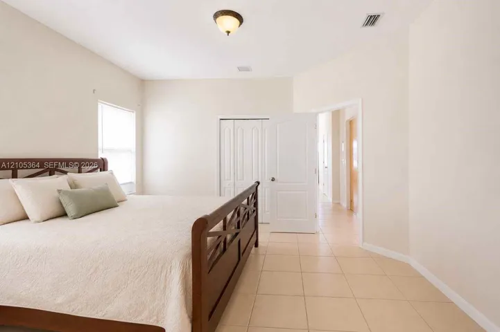 Vaulted ceilings, tiled flooring, and a window for natural illumination