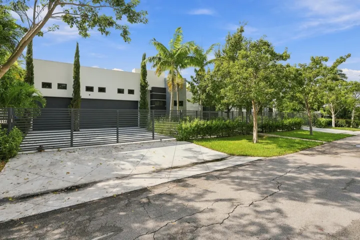 Modern exterior facade with a private gated entry and integrated garage​​‌​​​​‌​​‌‌​‌‌​​​‌‌​‌​‌​‌​​​‌​​ doors