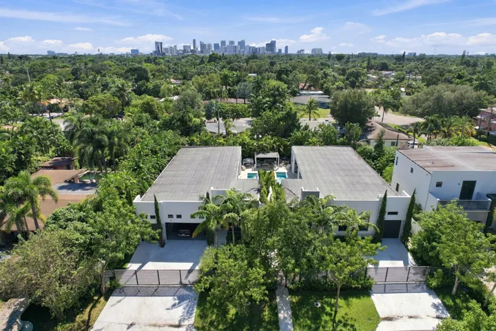 Modern architecture featuring flat roofs, private driveways, and dense surrounding foliage