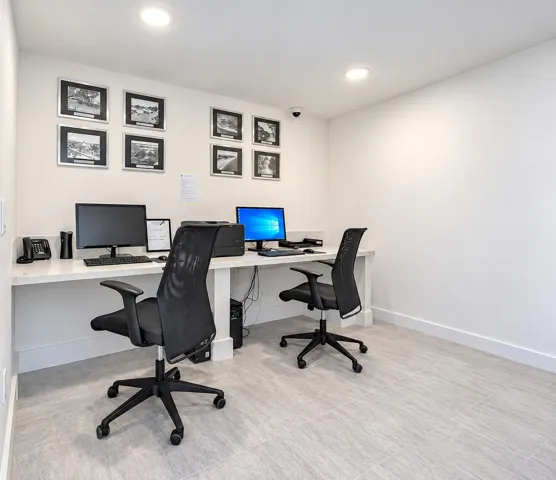 Dedicated workspace featuring a long countertop, recessed lighting, and tile flooring