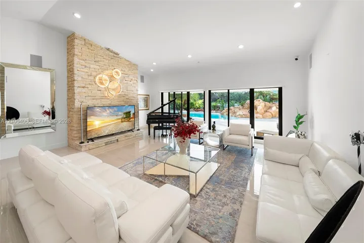 Recessed lighting illuminates a stone-finish accent wall with an integrated display ledge