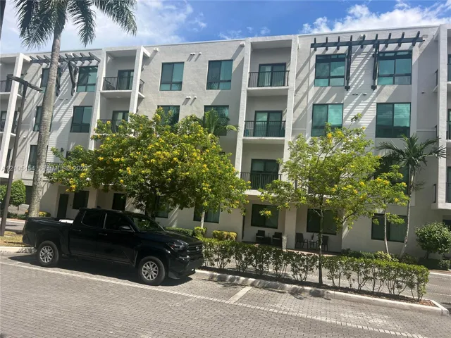 Multi-story structure with private balconies, contemporary windows, and architectural pergolas