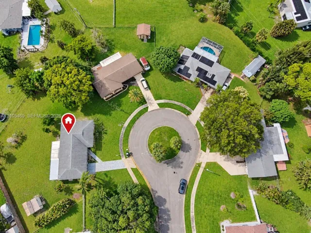 Circular driveway entrance with paved walkway