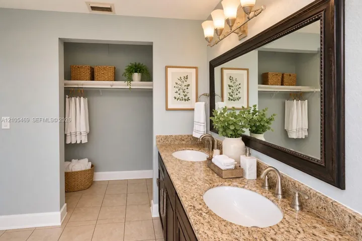 Virtual Staging Dual vanity with stone-finish countertops, undermount sinks, and brushed nickel fixtures