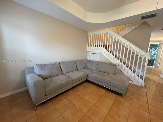 Staircase with white balusters and wood treads, accented by a built-in storage compartment