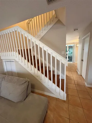 Staircase with wood-finish treads and white balusters