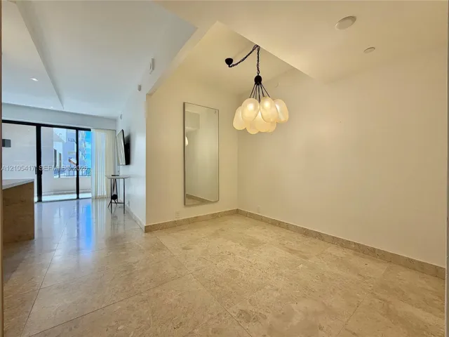 Recessed lighting, contemporary chandelier, full-height mirror, and tile flooring