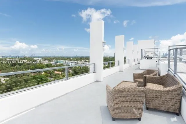 Expansive rooftop terrace with a light-colored surface and a cable railing system