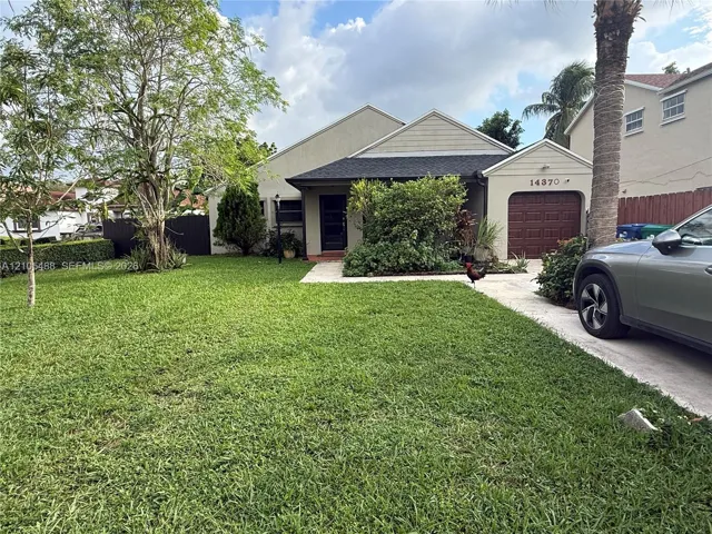 Front exterior with a manicured lawn, established landscaping, and a concrete​​‌​​​​‌​​‌‌​‌‌​​​‌‌​‌​‌​‌​​​‌​​ driveway