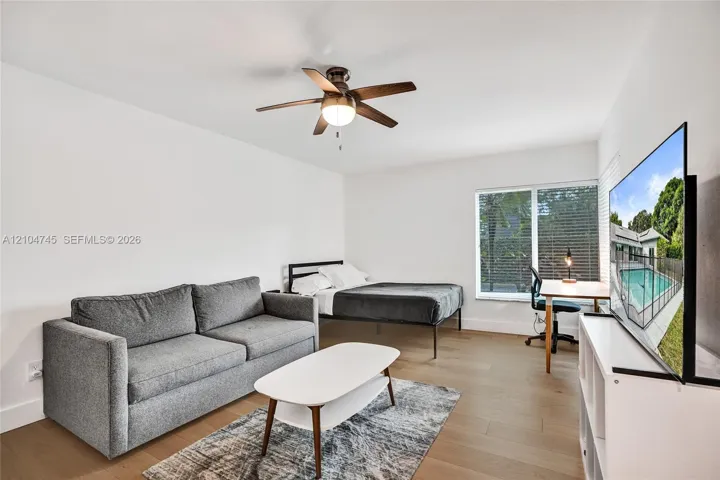 Recessed lighting, wood-finish flooring, ceiling fan, and window with blinds