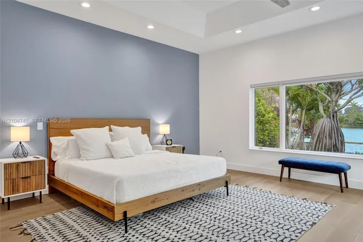 Tray ceiling, recessed lighting, wood-finish flooring, accent wall, expansive window