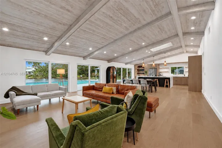 Vaulted wood-finish ceilings with recessed lighting, skylight, and wood-finish flooring