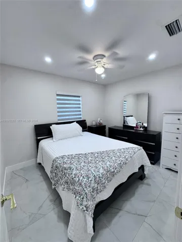 Recessed lighting, ceiling fan, window with horizontal blinds, and large format tile flooring