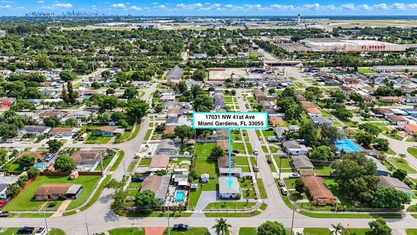Aerial perspective showcasing the property within a residential neighborhood with established landscaping