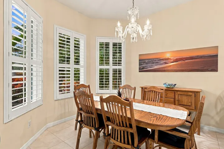 Bay window in dining room offers great views of golf course. The Waterford chandelier is included in sale.