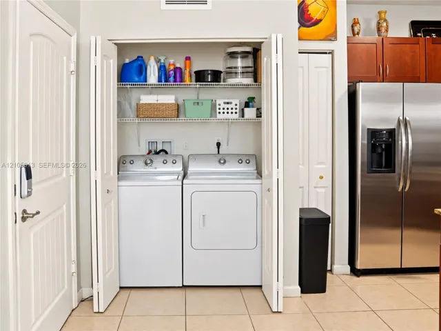 Laundry closet featuring bi-fold doors and tiered wire shelving