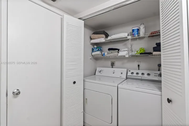 Convenient guest powder room and in-unit washer and dryer, providing everyday comfort and functionality at Mystic Pointe in Aventura.