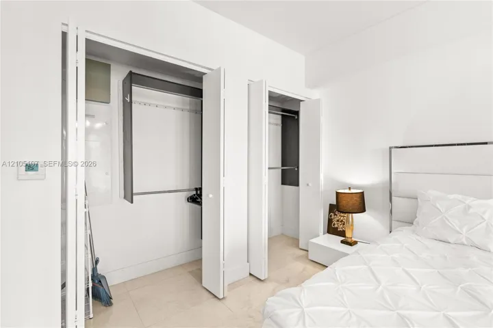 White walls with built-in closets featuring bi-fold doors