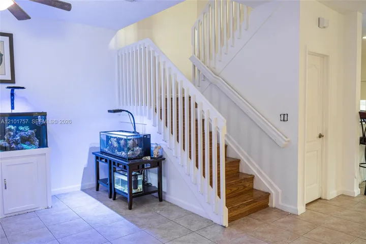 Wood-finish staircase with white risers and railing