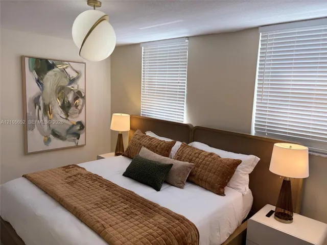 Modern spherical globe pendant light, two horizontal windows with slatted blinds, and minimalist built-in headboard