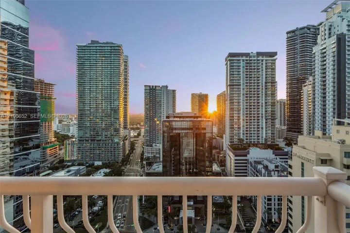Elevated balcony featuring a white powder-coated metal railing and an expansive urban skyline outlook
