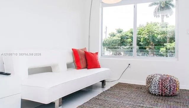 Large dual-pane sliding window with aluminum framing and mature exterior greenery