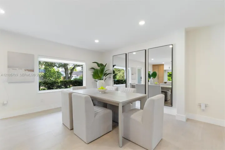 Neutral color palette featuring wood-finish flooring, recessed lighting, and large windows