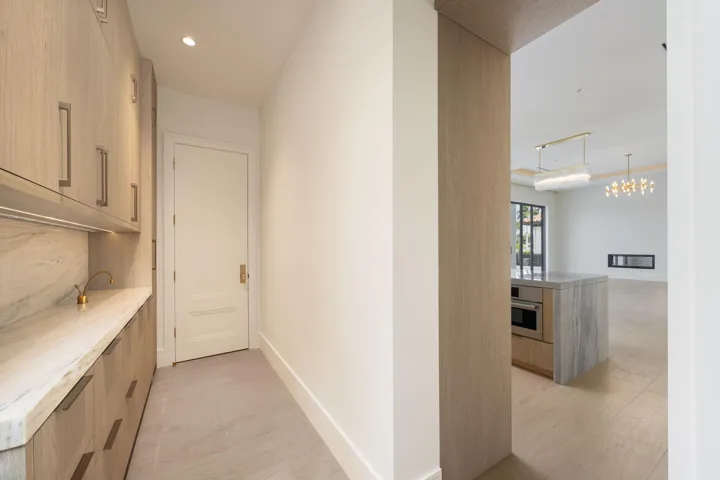 pantry floor to ceiling cabinetry , marble counter & backsplash and instahot faucet. ac closet at end of room