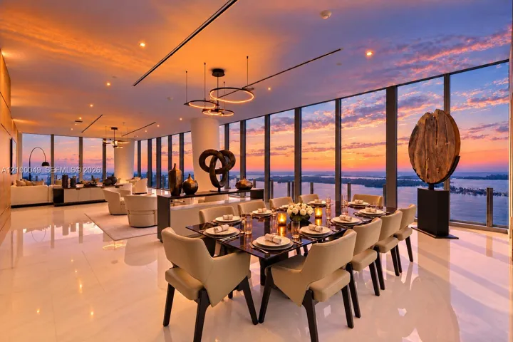 Expansive floor-to-ceiling windows, polished floor tiles, modern recessed lighting, contemporary pendant light fixtures, and a wood accent wall