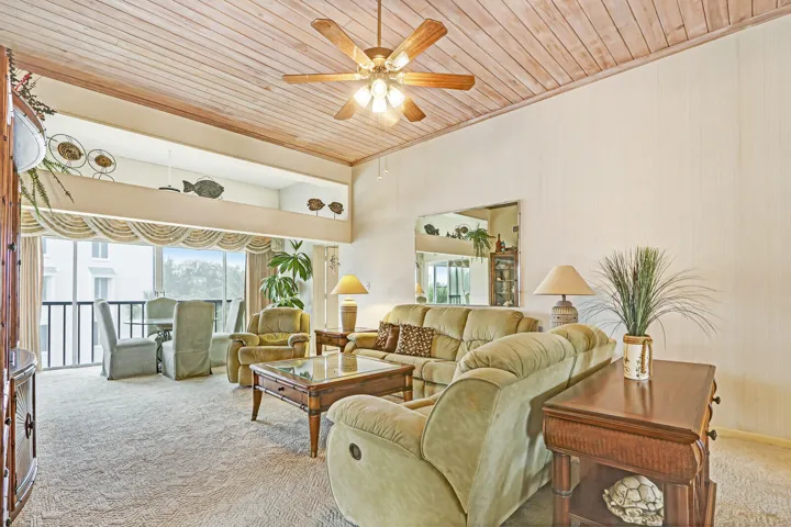 Wood-finish planked ceiling with a ceiling fan