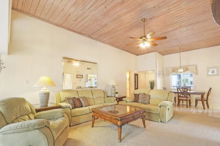 Vaulted wood-plank ceiling with a ceiling fan