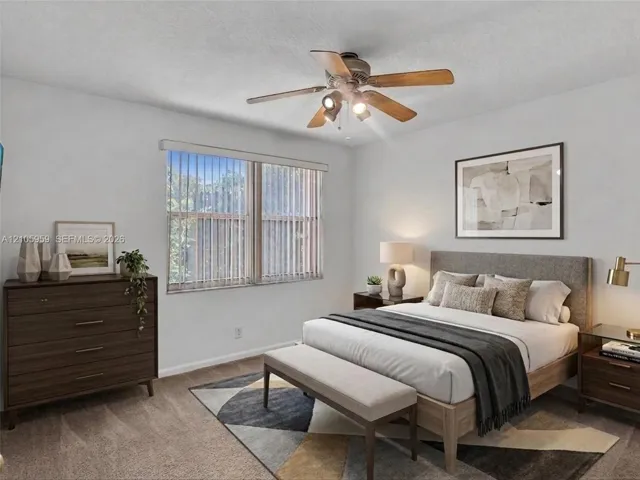 Neutral wall palette, ceiling fan with integrated lighting, and vertical window blinds