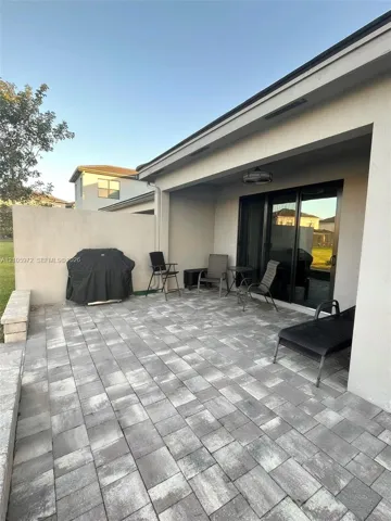 Covered patio featuring concrete paver flooring, a perimeter masonry privacy wall, and recessed ceiling lighting
