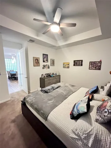 Tray ceiling with integrated recessed lighting and a central ceiling fan