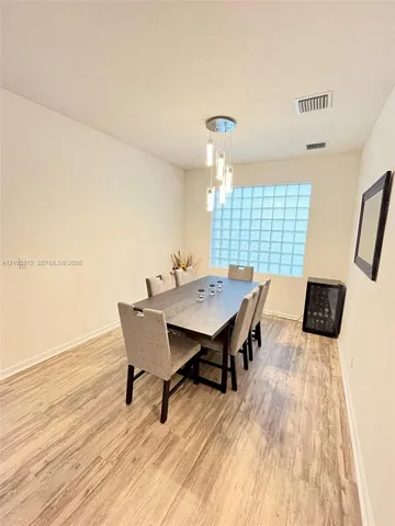 Wood-finish flooring, glass block window, and multi-pendant light fixture