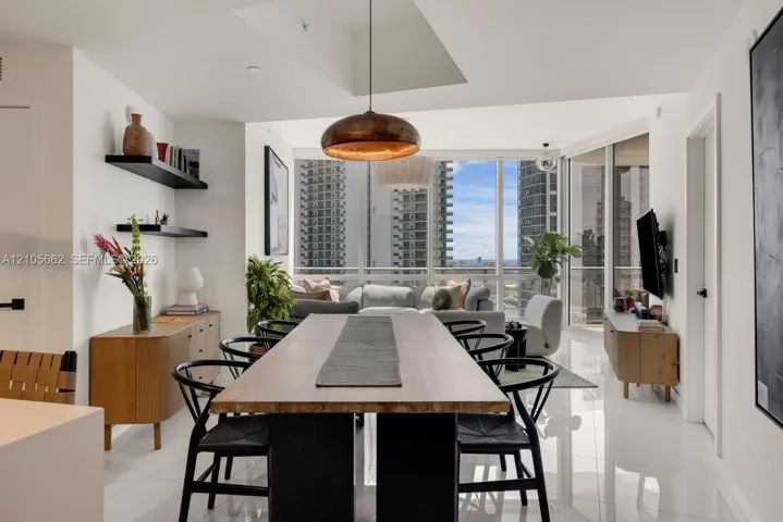 Open-concept space featuring floor-to-ceiling windows, polished tile flooring, recessed ceiling lighting, and matte black wall-mounted shelving